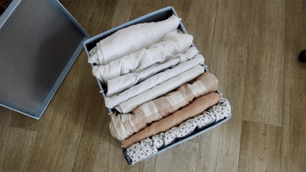 organized fabric stash with fabrics sorted by color, showing a curated collection