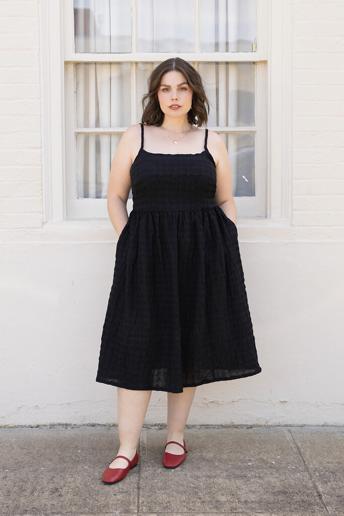 woman modeling in black Mora dress