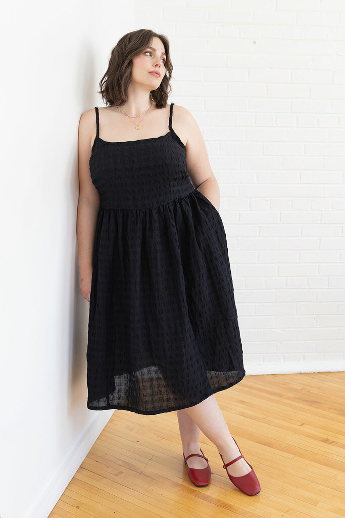 woman standing in black Mora dress