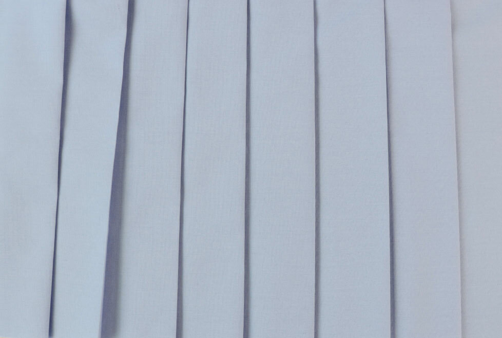 [image-03: Close-up of poplin fabric showing its characteristic ribbed texture and crisp appearance] -poplin.jpg (pleated)