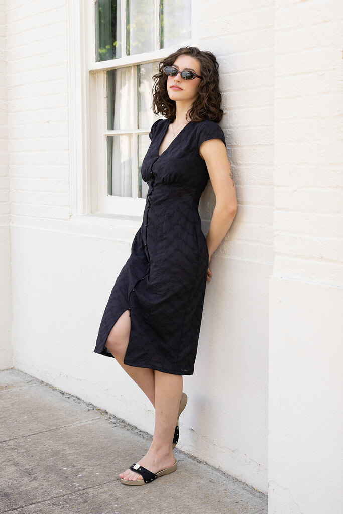 woman modeling black lilac dress